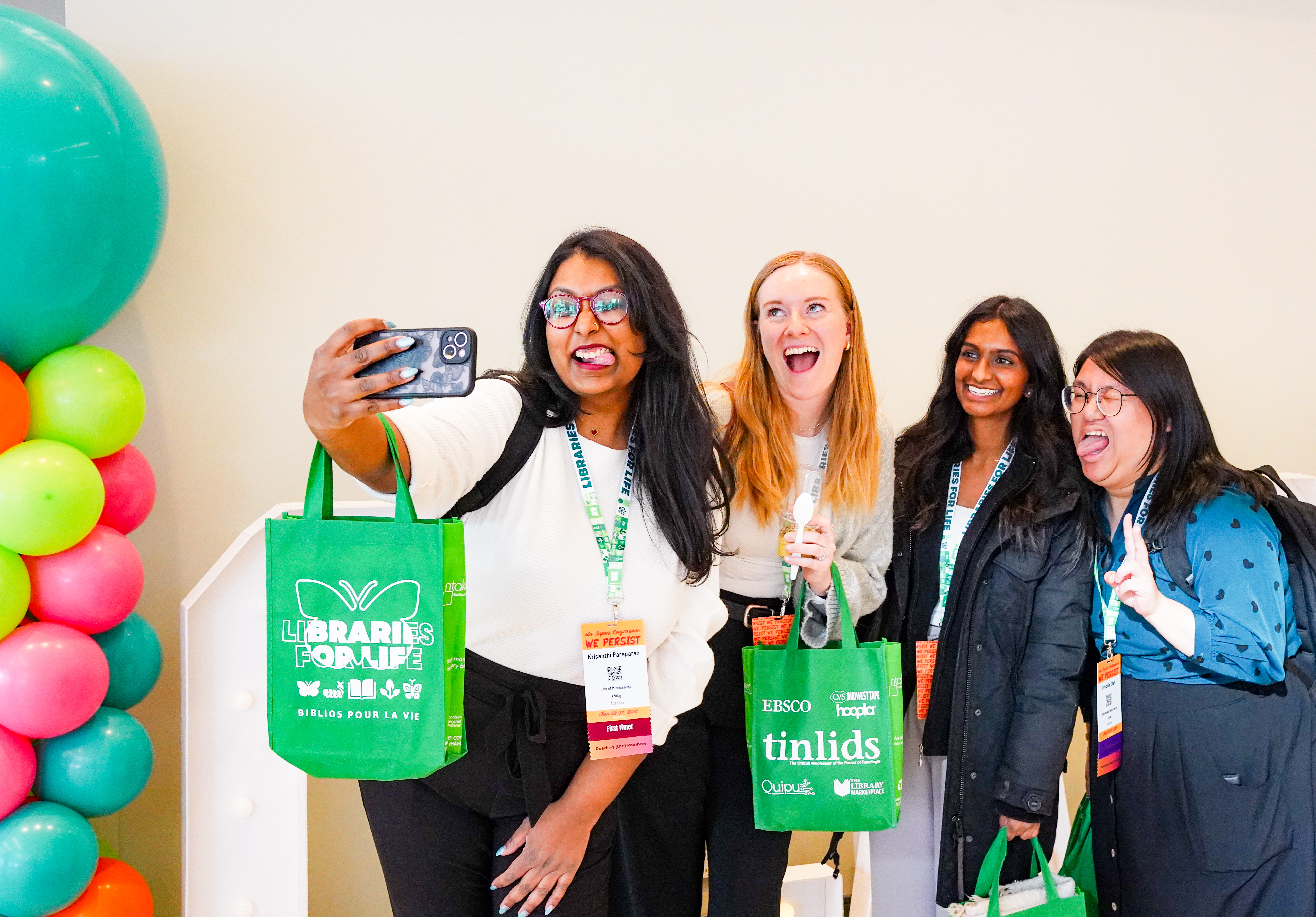 Group of four people making funny faces for an OLA selfie.